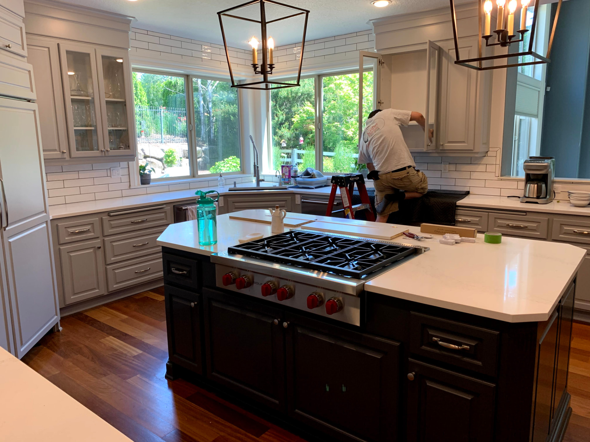 Electrician wiring cabinet lighting in a kitchen