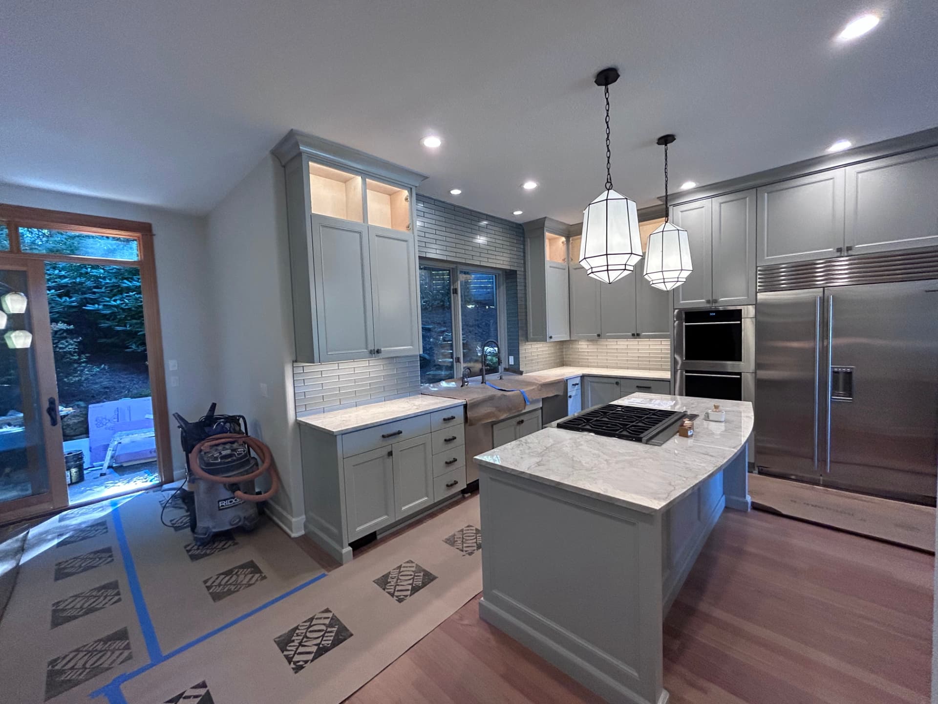 High-end kitchen with pendant lights over a marble island